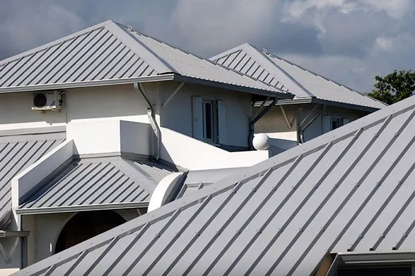 Close-up of modern metal roofing on residential houses in a tropical climate.