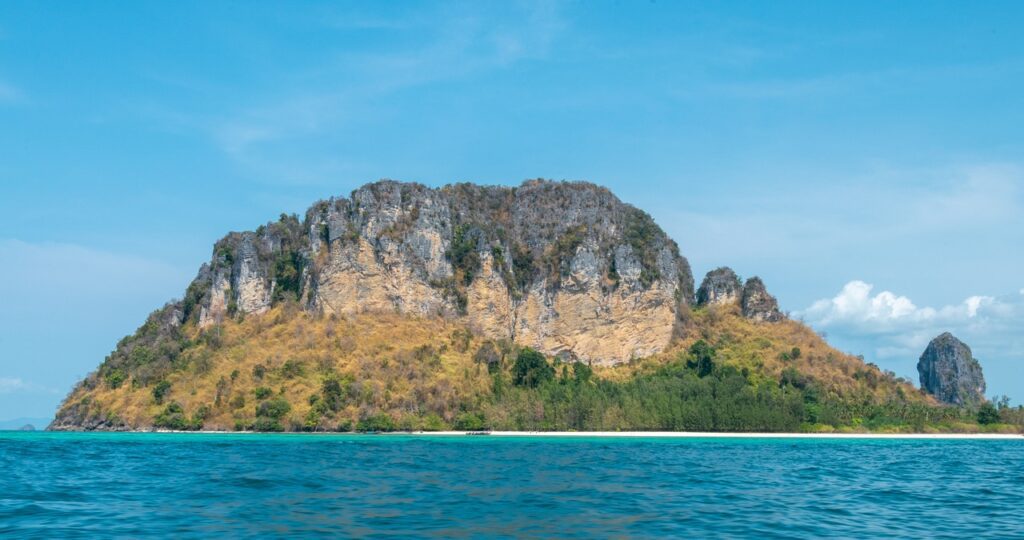 Lush green island landscape with solar panels, local organic farming, and eco-friendly transportation in Koh Samui.