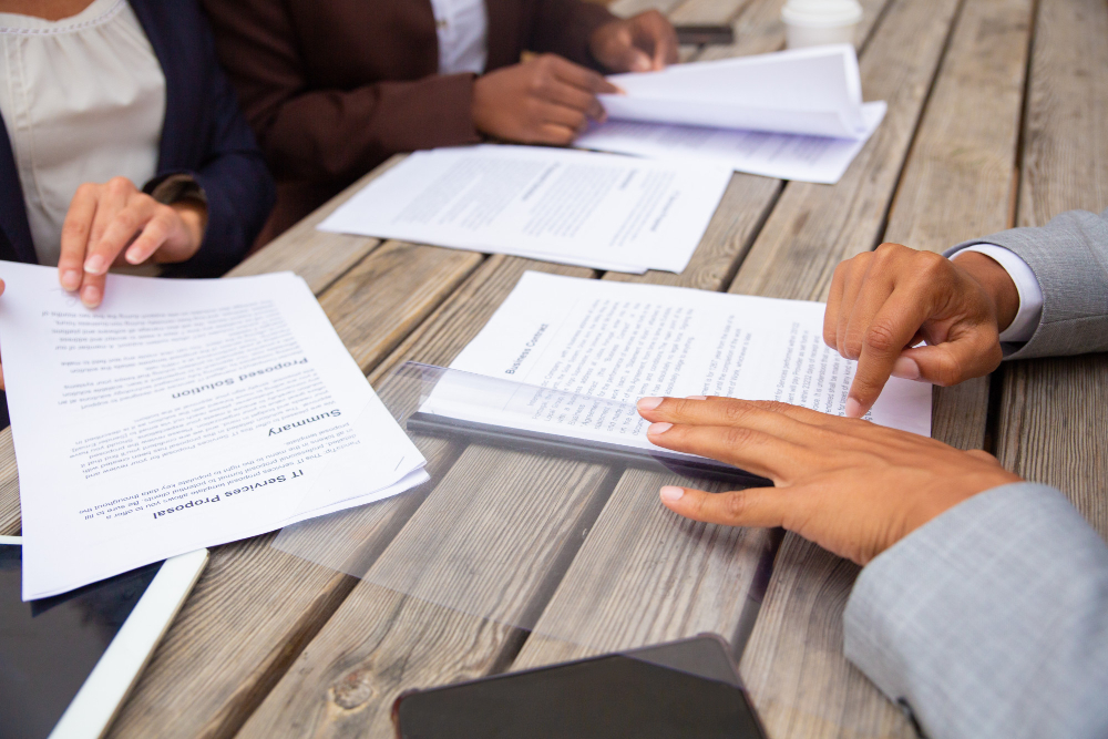 Construction project manager reviewing detailed contracts and documentation to ensure a smooth, dispute-free building process.
