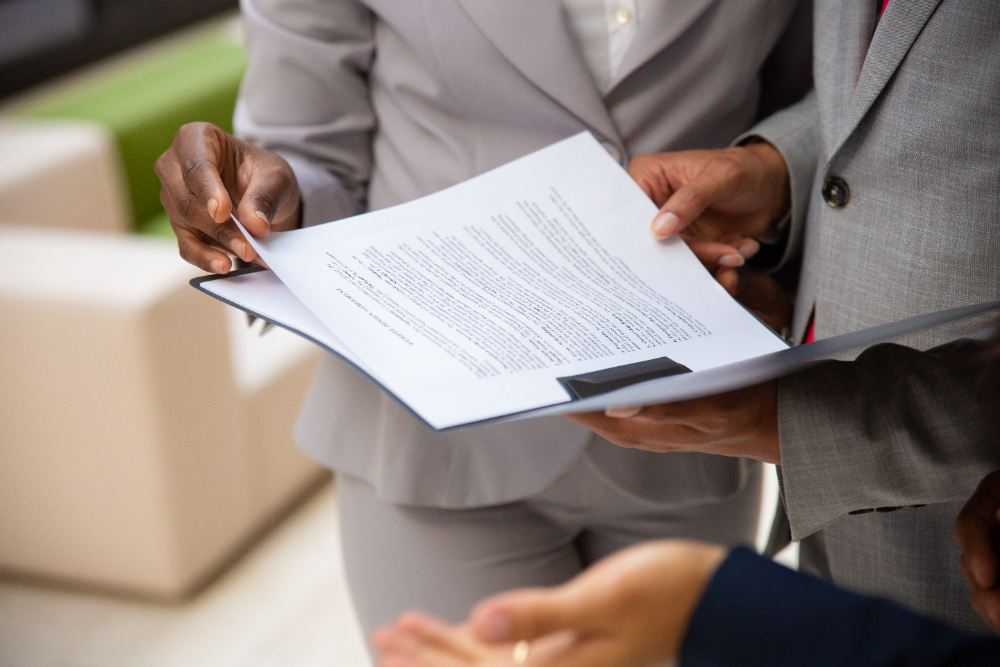 Construction project manager reviewing detailed contracts and documentation to ensure a smooth, dispute-free building process.