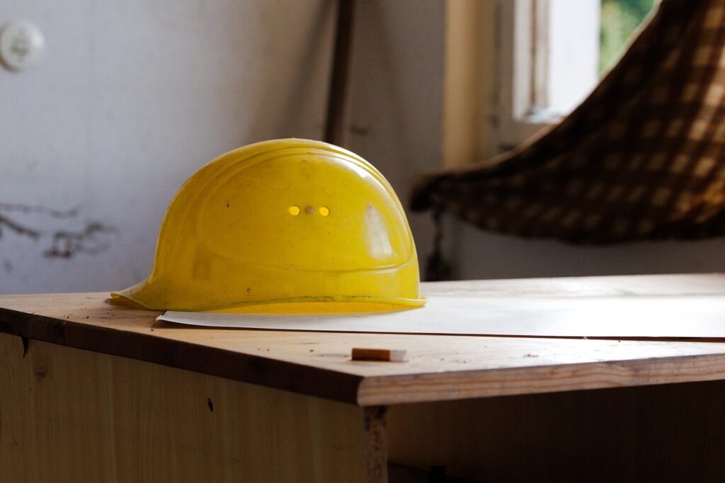 A construction site with builders working under proper warranties and insurance coverage.